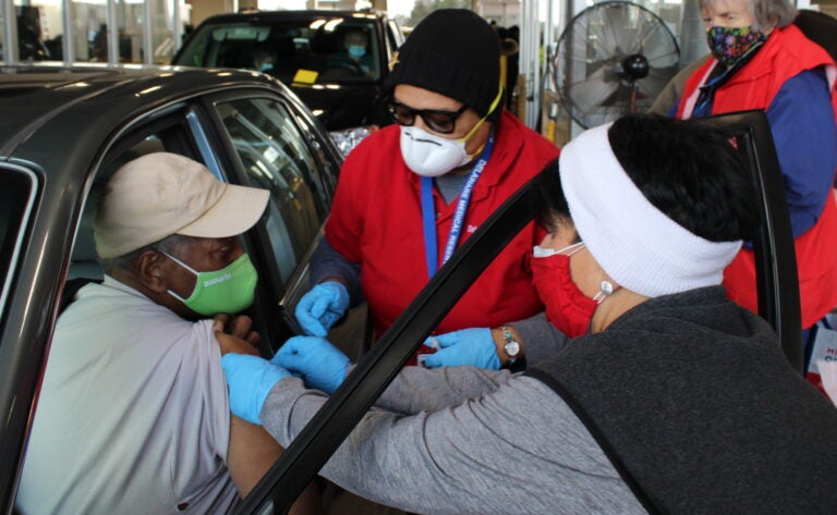 A Delaware resident is vaccinated against COVID-19 at a drive-thru site