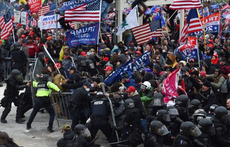 Pro-Trump insurrectionists clash with police and security forces as they push barricades to storm the U.S. Capitol