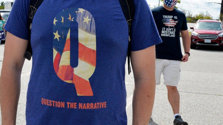 A man wears a QAnon shirt while boarding a shuttle bus in Londonderry, N.H., on Aug. 28, 2020. (Joseph Prezioso/AFP via Getty Images)