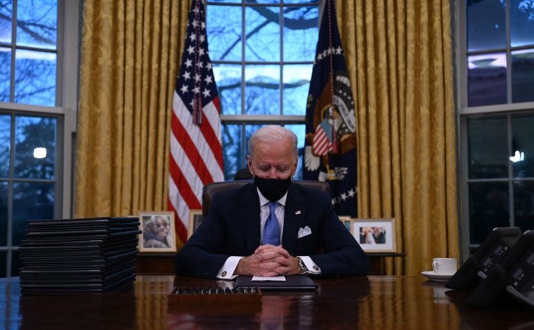 President Biden sits in the Oval Office at the White House