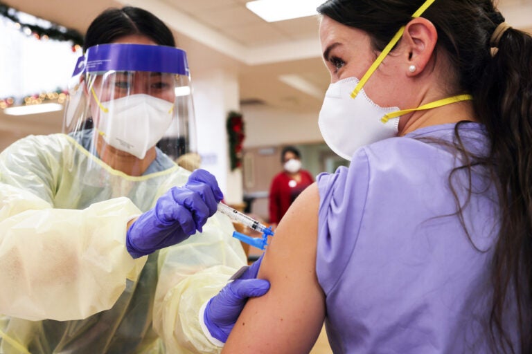 Staff and residents of the Ararat Nursing Facility in the Mission Hills neighborhood of Los Angeles got COVID-19 shots on Jan.7. Coronavirus cases, hospitalizations and deaths have been surging throughout the county. (Mario Tama/Getty Images)