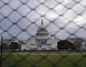 The U.S. Capitol is seen behind fences