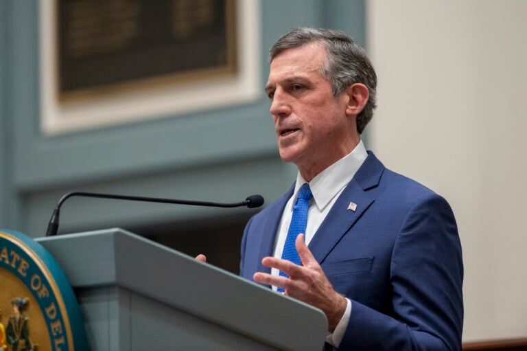 Delaware Gov. John Carney speaks at a podium