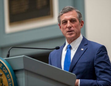 Delaware Gov. John Carney speaks at a podium