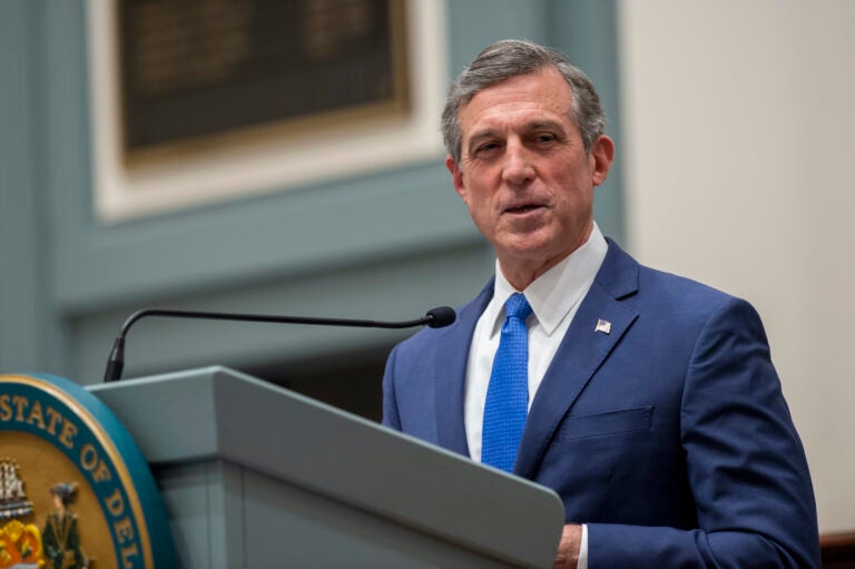 Delaware Gov. John Carney speaks at a podium