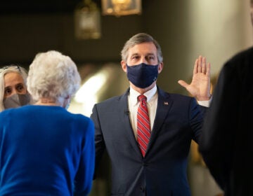 Gov. John Carney takes the oath of office to start his second term in a virtual ceremony held outside his office in Legislative Hall in Dover.