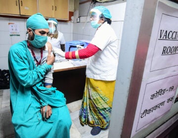 Volunteers and health officials hold a dry run for the coronavirus vaccine at a hospital in Allahabad