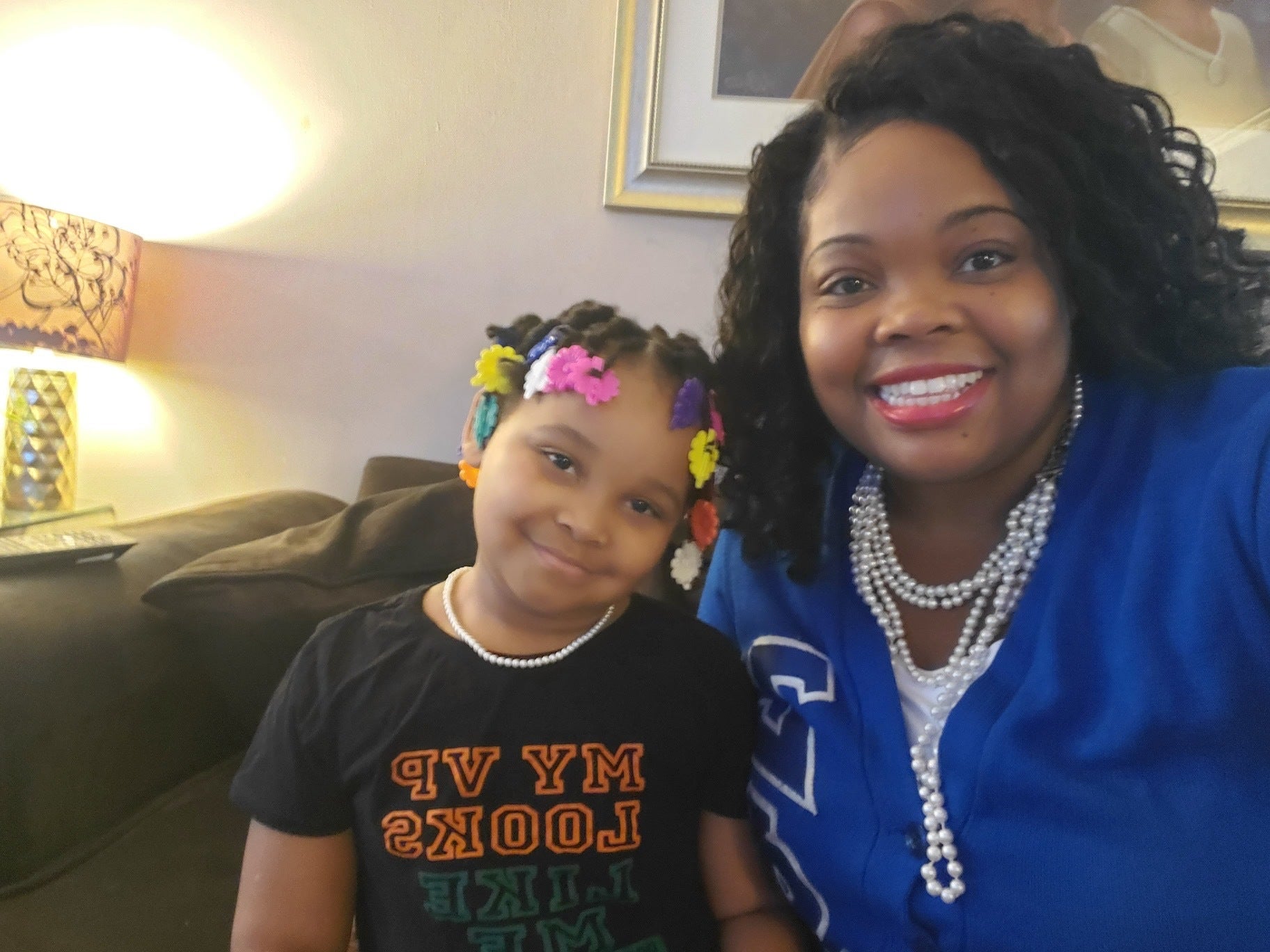 Councilmember Katherine Gilmore-Richardson (right) wears sorority blue and pearls while sitting next to her 6-year-old daughter, Katherine