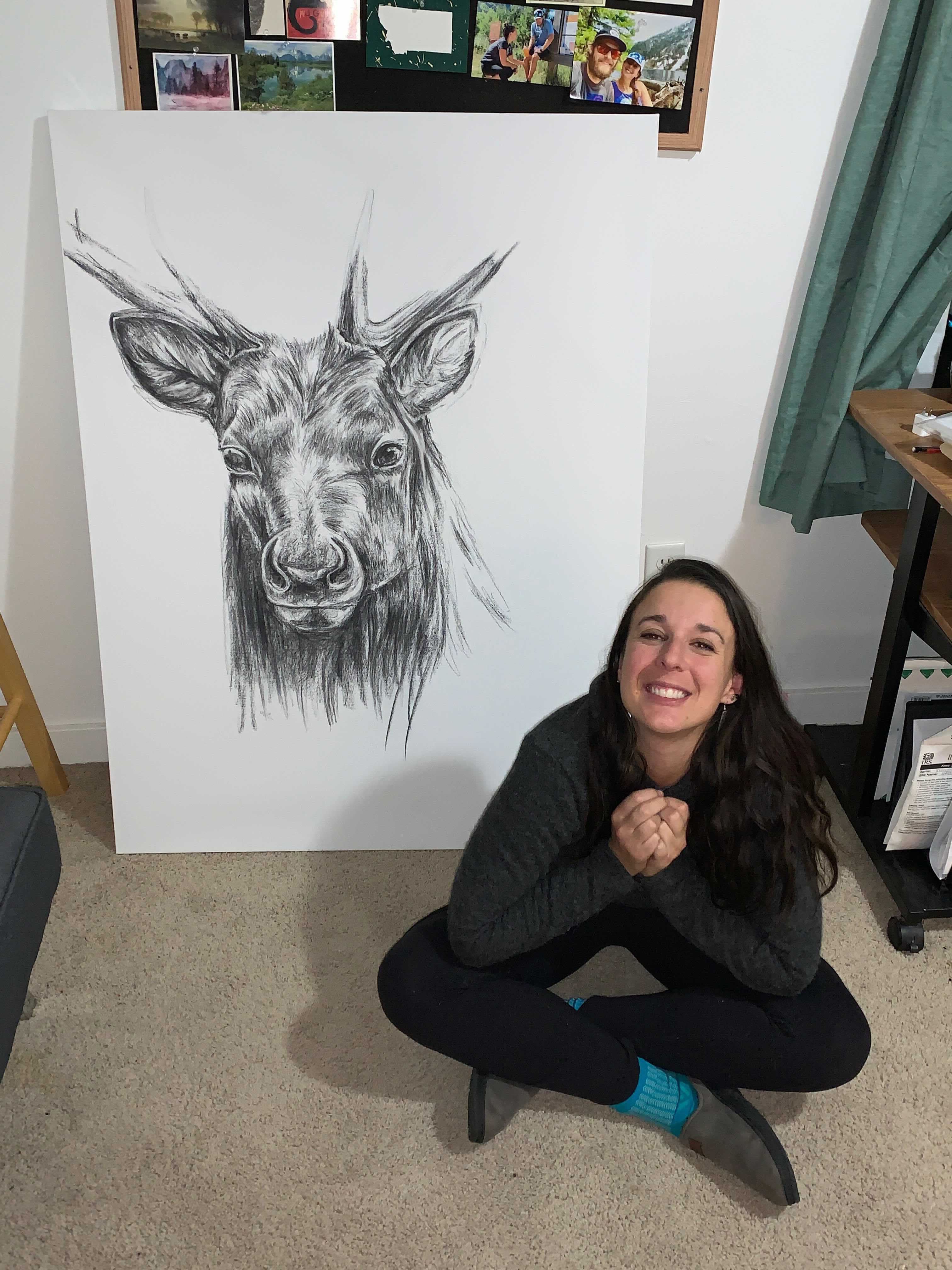 Maggie Slepian next to a drawing of an elk