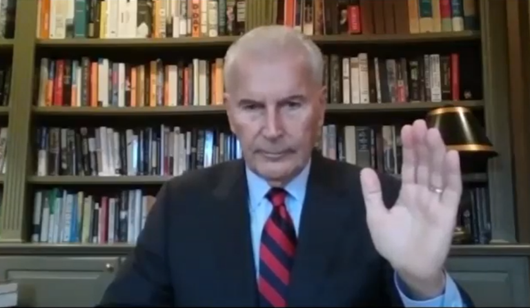 Wilmington Mayor Mike Purzycki holds his hand in the air as he is sworn in for his second term.