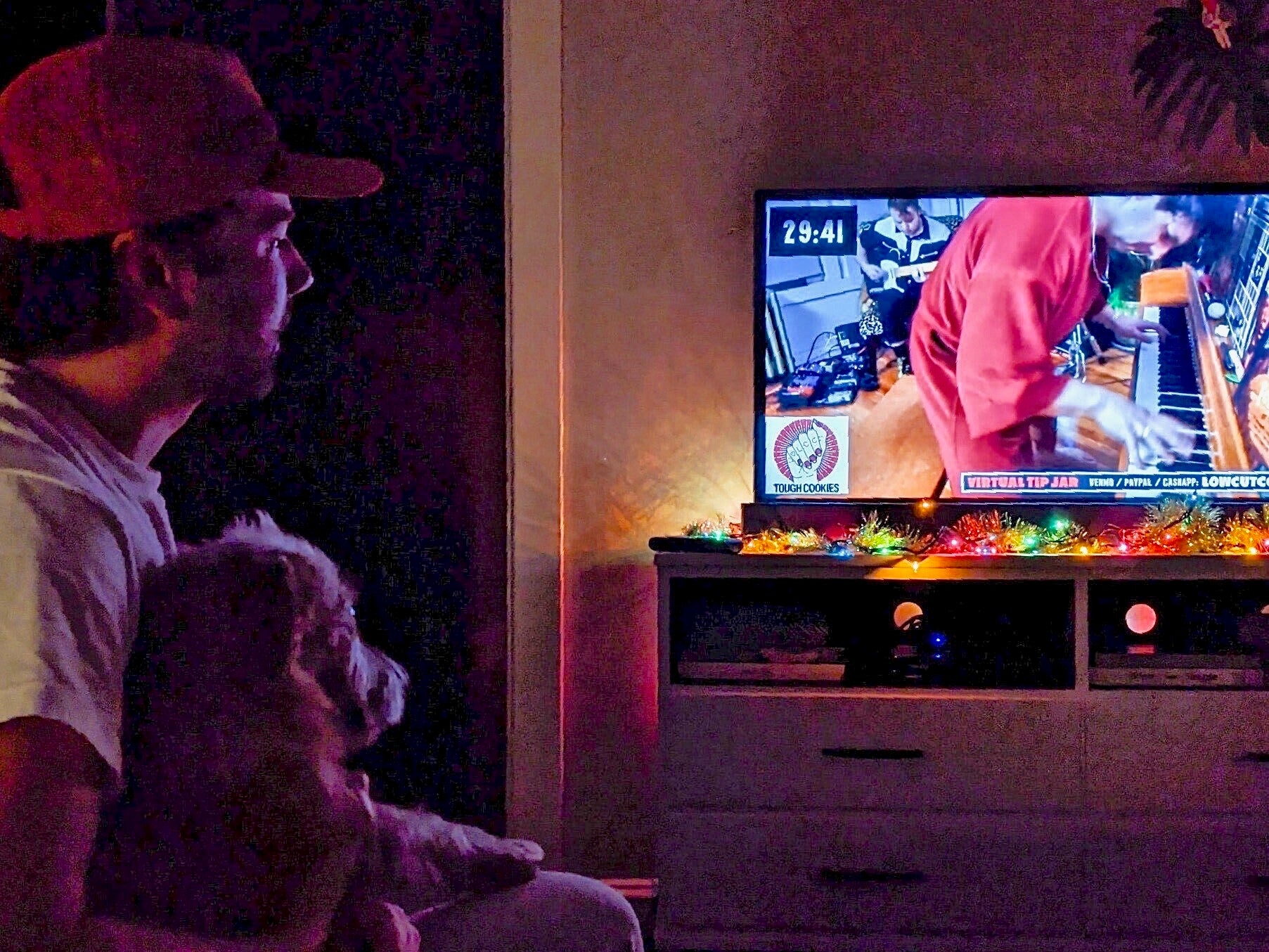 Mike Kaiser and his dog, Rooney, watching a Low Cut Connie livestream concert New Year's Eve. 