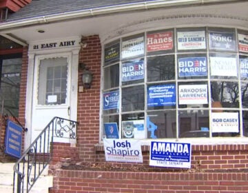 Multiple campaign signs and posters, including some supporting President Joe Biden and Vice President Kamala Harris, adorn the front window of the Montgomery County Democratic Committee’s Norristown office. (NBC10)