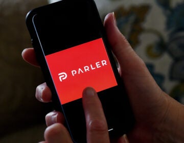 This illustration picture shows social media application logo from Parler displayed on a smartphone in Arlington, Virginia on July 2, 2020.