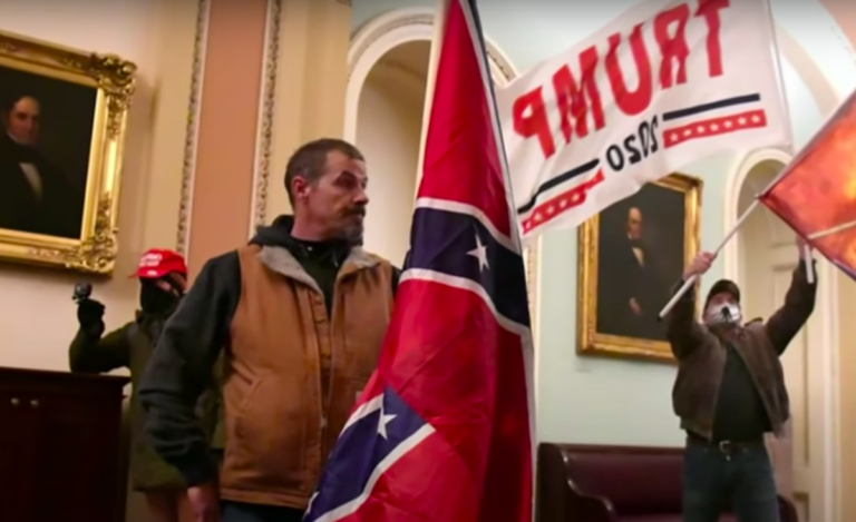 Kevin Seefried carries a Confederate flag inside the U.S. Capitol