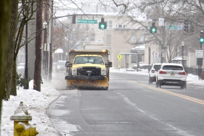 A plow clears the slushy snow from Route 537 in Moorestown, N.J.