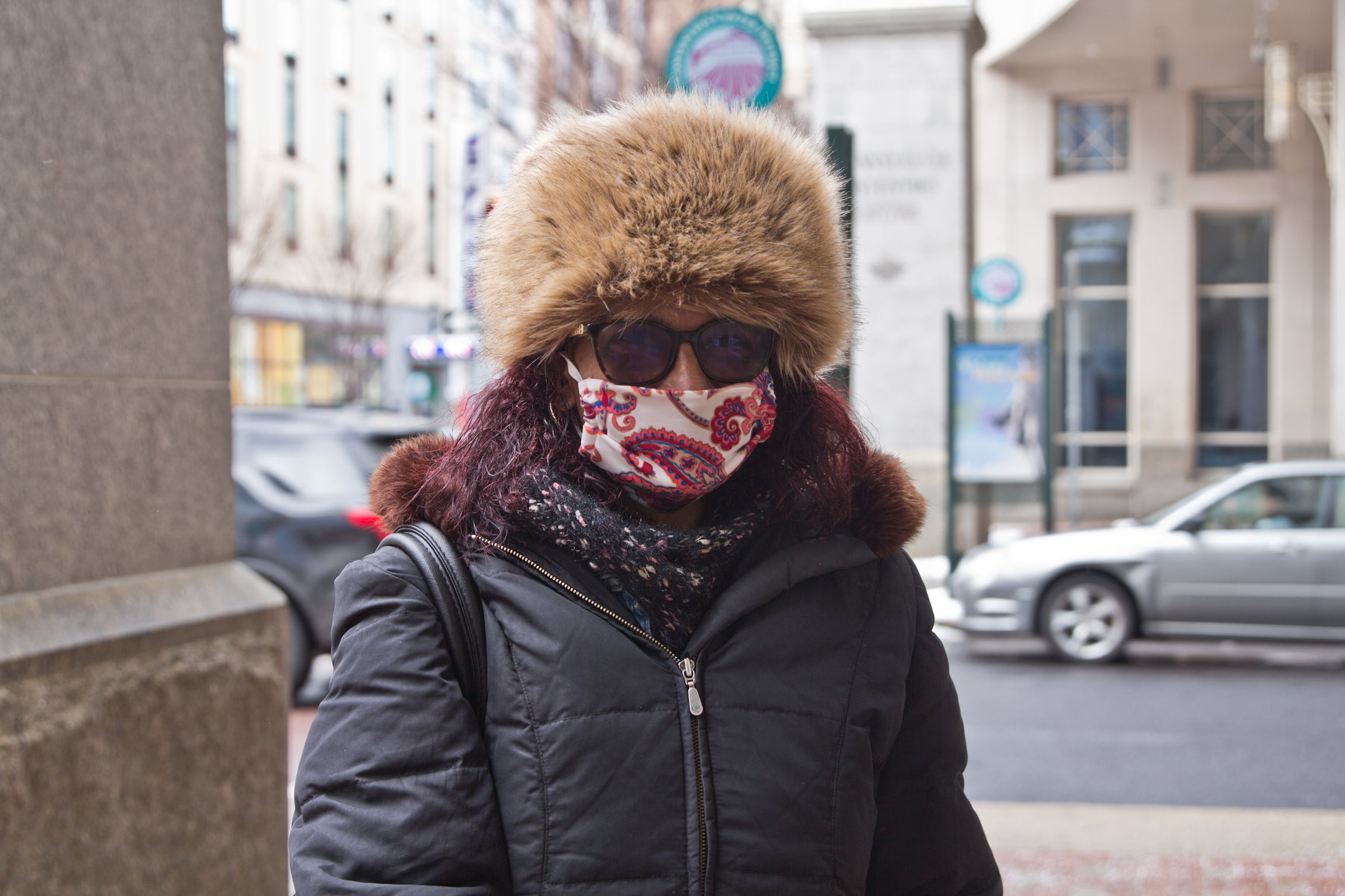 Zelice Williams, wearing a face mask, stands outside the vaccine clinic