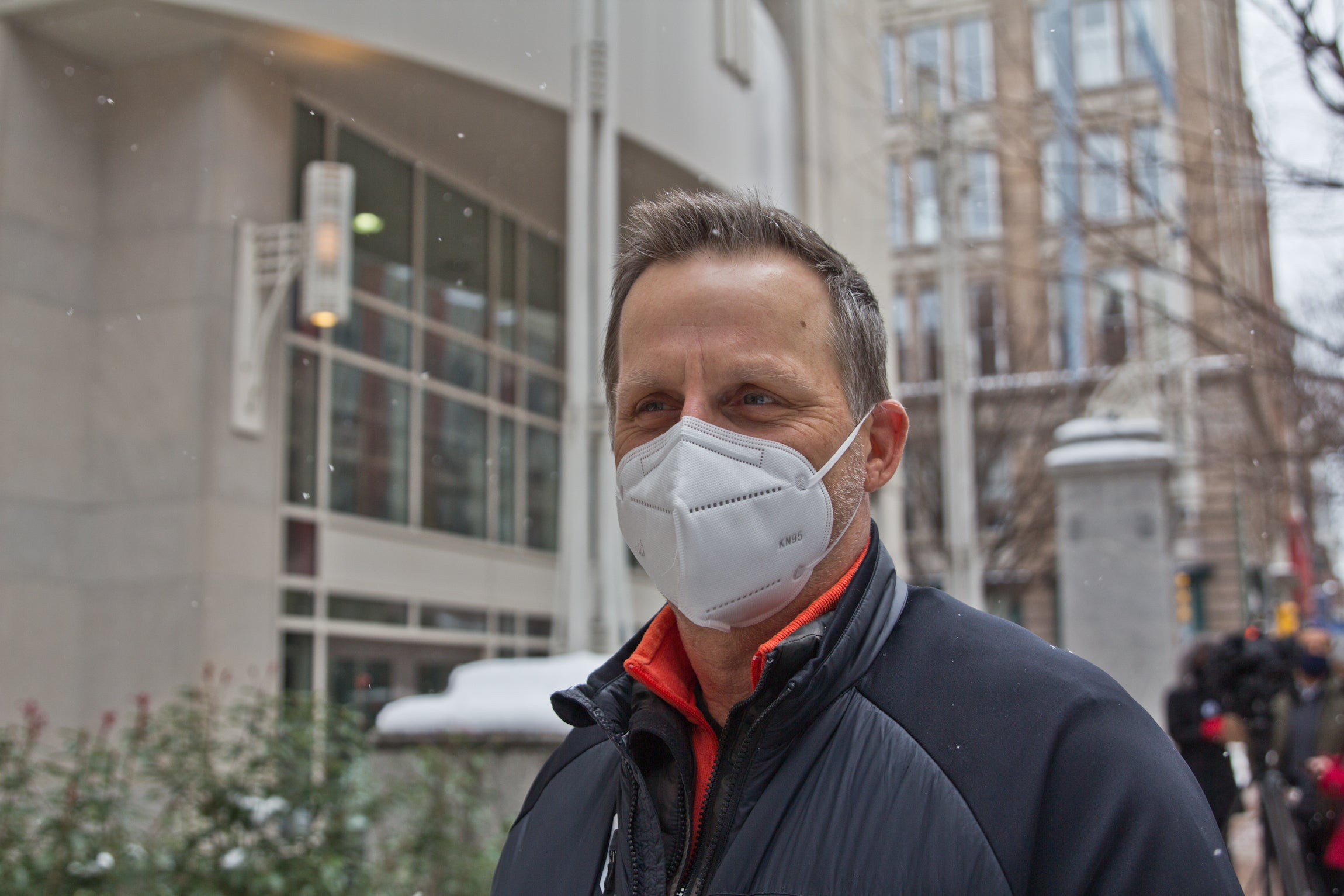 Ted Jelesiewicz, wearing a face mask, stands outside the vaccine clinic