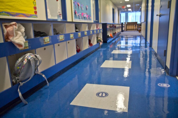 Markers on the floor instruct students to physically distance