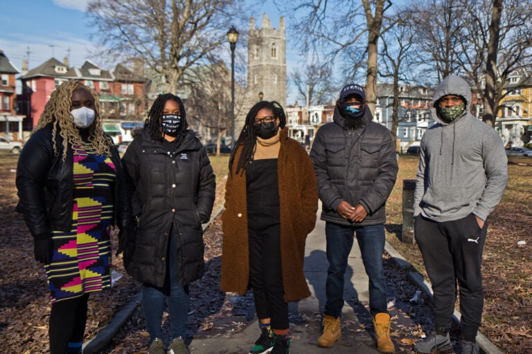 (From left) Nikki Grant, with the Amistad Law Project, Kendra Van de Water with YEAH Philly, Clarise McCants with the Movement Alliance Project, and James Aye and Kameron Troy with YEAH Philly, at Malcolm X Park in West Philadelphia. (Kimberly Paynter/WHYY)