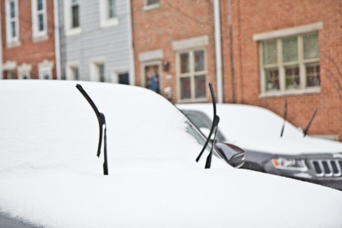 Cars parked on Philly street in the snow