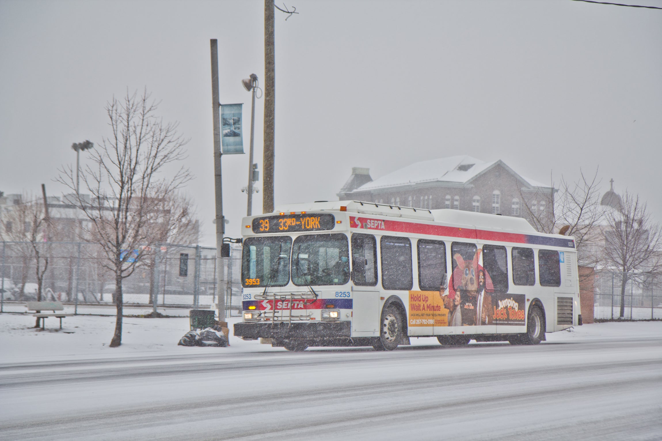 A SEPTA bus glides down Aramingo Avenue in the snow