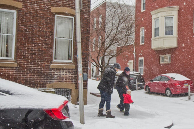 A family takes a winter stroll in Philadelphia’s Port Richmond neighborhood