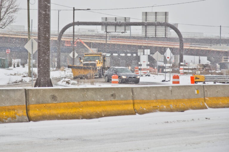 A PennDOT vehicle plows the entrance to 95 North during a snow storm