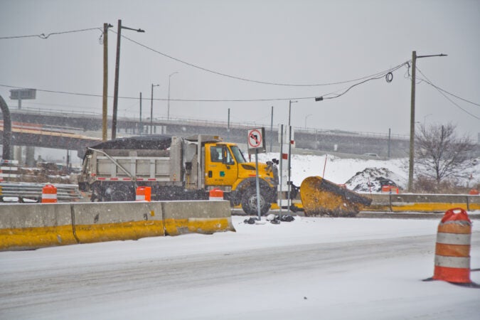 A PennDOT vehicle plows the entrance to 95 North during a snow storm