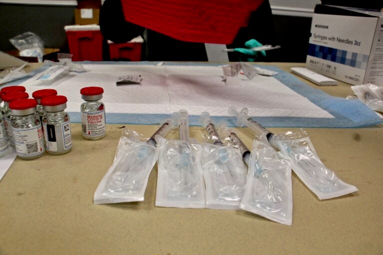 Doses of Moderna's COVID-19 vaccine are prepared at the Liacouras Center, where the Black Doctors Consortium held a 24-hour mass vaccination clinic on Feb. 19, 2021. (Emma Lee/WHYY)