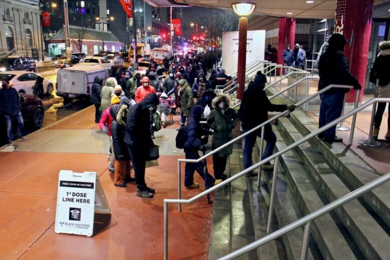 Philadelphians wait in line outside the Liacouras Center at Temple University, where the Black Doctors COVID-19 Consortium was holding a 24-hour vaccination clinic. (Emma Lee/WHYY)