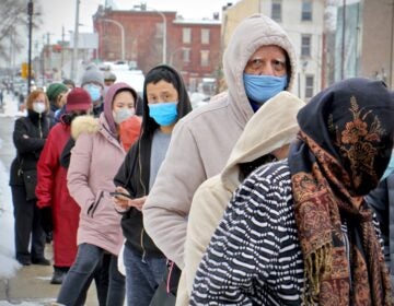 People wait in line for COVID-19 vaccines