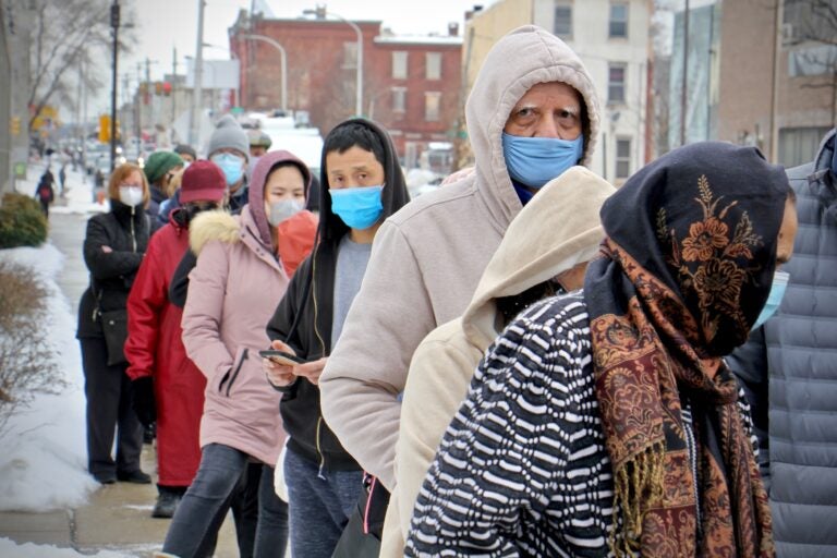 People wait in line for COVID-19 vaccines