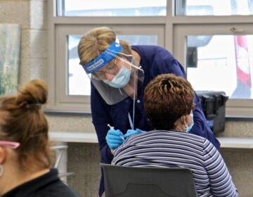 A person receives a COVID-19 vaccine