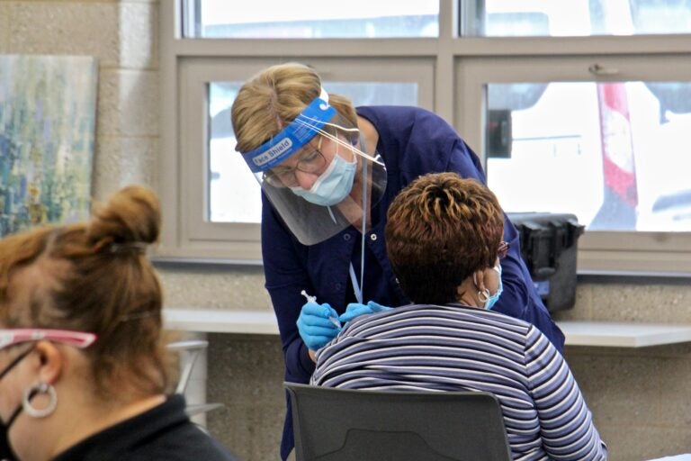 A person receives a COVID-19 vaccine