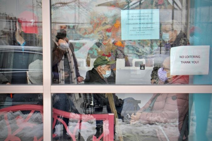 People with appointments wait in line at Philadelphia's first standing city-run COVID-19 vaccination clinic