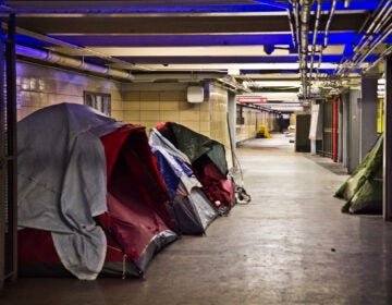 Tents and sleeping bags line the tunnels of the Locust Street Patco Station in Center City on Feb. 23, 2021. (Kimberly Paynter/WHYY)