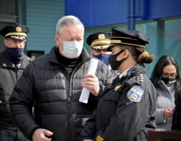 Philadelphia Mayor Jim Kenney and Police Commissioner Danielle Outlaw confer during a press event at Olney Transportation Center, where a mass shooting occurred on Feb. 17, 2021. (Emma Lee/WHYY)