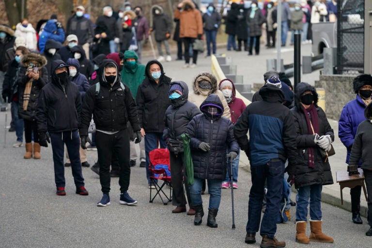 People wait in line for the COVID-19 vaccine