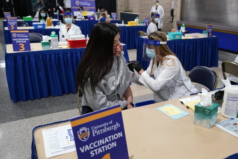 Tiffany Husak, left, a nursing student at the Community College of Allegheny County, receives her first dose of the Moderna COVID-19 Vaccine, during a vaccination clinic hosted by the University of Pittsburgh and the Allegheny County Health Department at the Petersen Events Center, in Pittsburgh, Thursday, Jan. 28, 2021. (Gene J. Puskar/AP Photo)