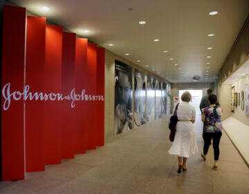 In this July 30, 2013, file photo, people walk along a corridor at the headquarters of Johnson & Johnson in New Brunswick, N.J. (AP Photo/Mel Evans)