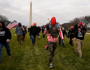 FILE - In this Jan. 6, 2021, file photo, people march with those who say they are members of the Proud Boys as they attend a rally in Washington in support of President Donald Trump. In its annual report set to be released Monday, Feb. 1, 2021, the Southern Poverty Law Center said it identified 838 active hate groups operating across the U.S. in 2020. The SPLC’s report comes out nearly a month after a mostly white mob of Trump supporters and members of far-right groups violently breached the U.S. Capitol building. (AP Photo/Carolyn Kaster, File)
