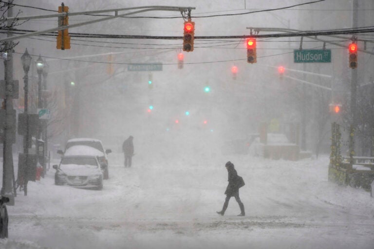 File photo: A few pedestrians are seen walking in the heavy snow and wind in Hoboken, N.J., Monday, Feb. 1, 2021. (AP Photo/Seth Wenig)