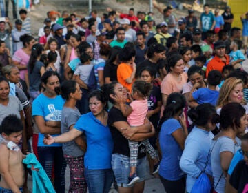 In this Aug. 30, 2019, file photo, migrants, many of whom were returned to Mexico under the Trump administration's 