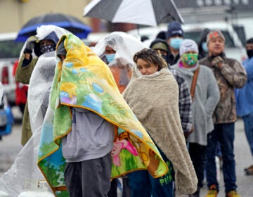 People wait in line to fill propane tanks Wednesday, Feb. 17, 2021, in Houston. Customers waited over an hour in the freezing rain to fill their tanks. (AP Photo/David J. Phillip)