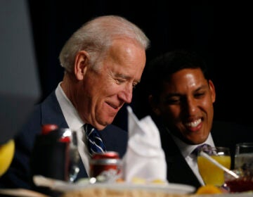 Then-Vice President Joe Biden and USAID administrator Raj Shah are seated together at the National Prayer Breakfast in Washington, Thursday, Feb. 6, 2014. (AP Photo/Charles Dharapak)