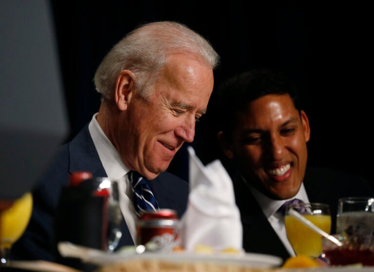 Then-Vice President Joe Biden and USAID administrator Raj Shah are seated together at the National Prayer Breakfast in Washington, Thursday, Feb. 6, 2014. (AP Photo/Charles Dharapak)