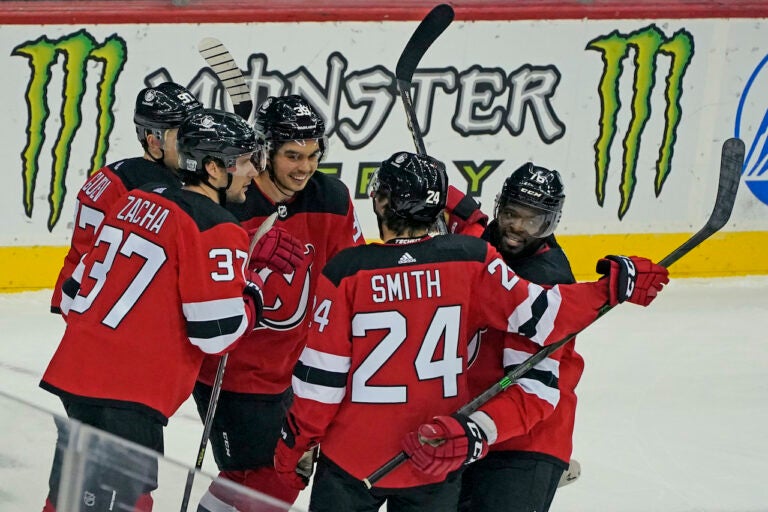 New Jersey Devils celebrate with center Pavel Zacha (37) after he scored a goal