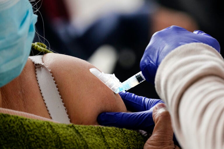 A person receives a COVID-19 vaccinations at a 24-hour, walk-up clinic hosted by the Black Doctors COVID-19 Consortium