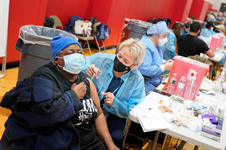 Mary Jenkins, left, receives the COVID-19 vaccine in Paterson