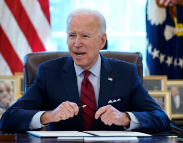 President Joe Biden signs a series of executive orders in the Oval Office